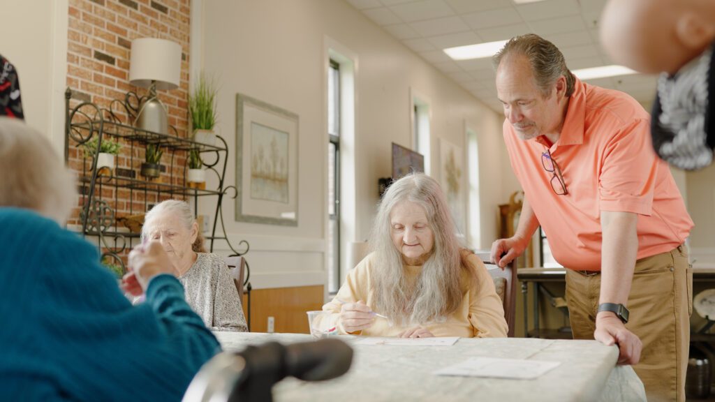 A man smiles with a woman at a skilled nursing facility and nursing home